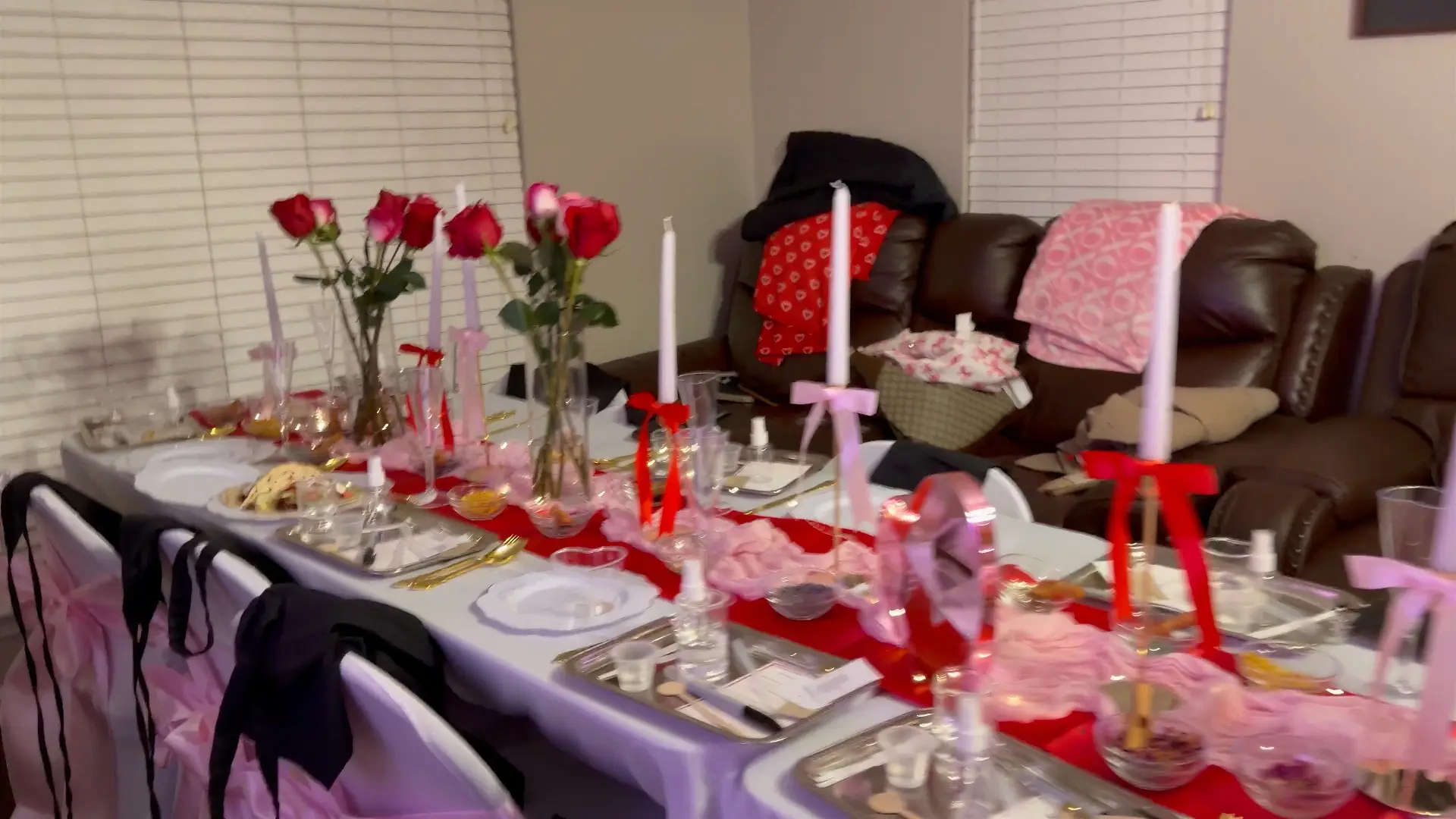 Valentine themed tablescape with roses, taper candles and pink accents