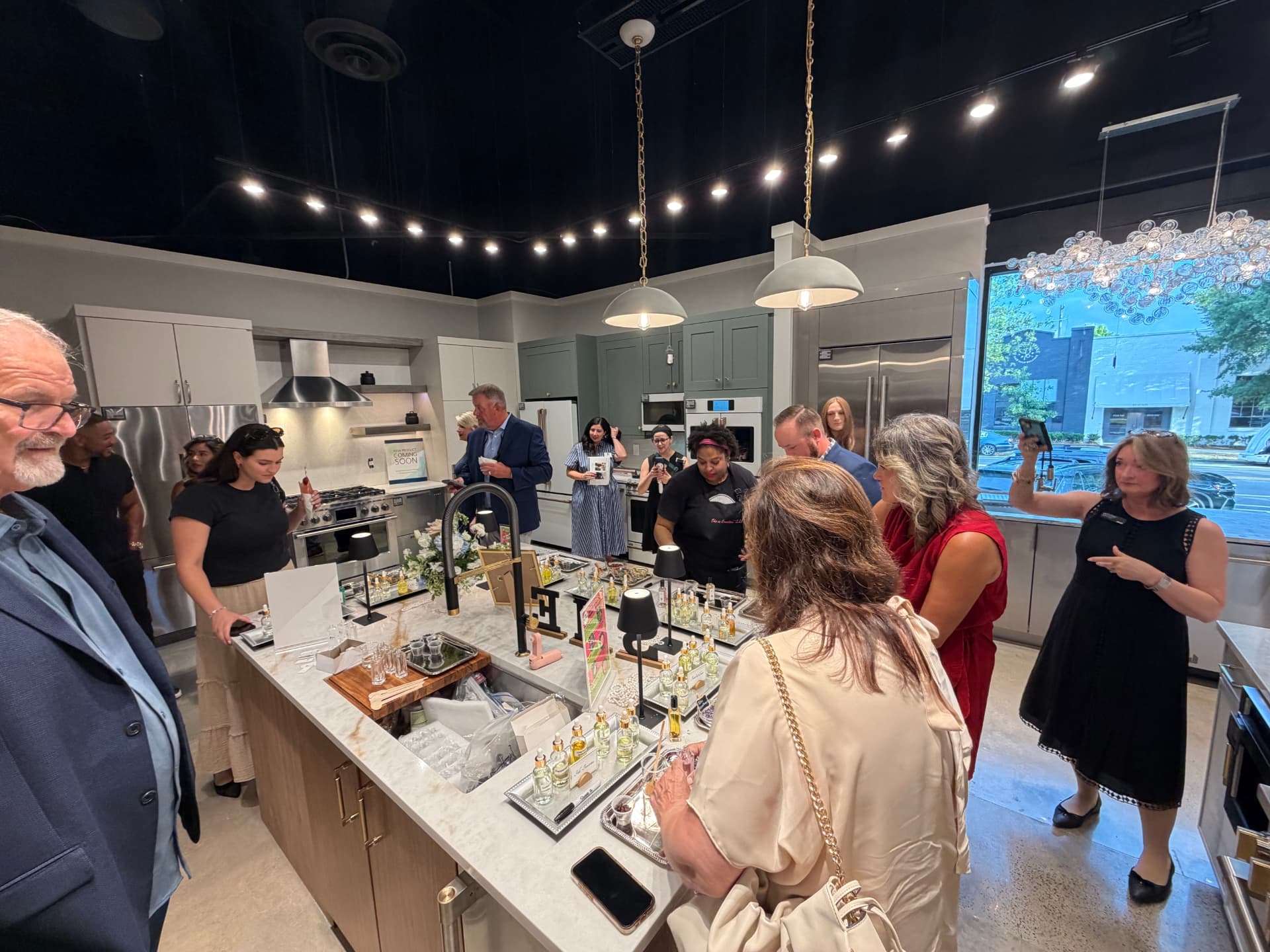 The Luminé Bar room spray station at the Ferguson Home grand opening, with guests creating custom home fragrances