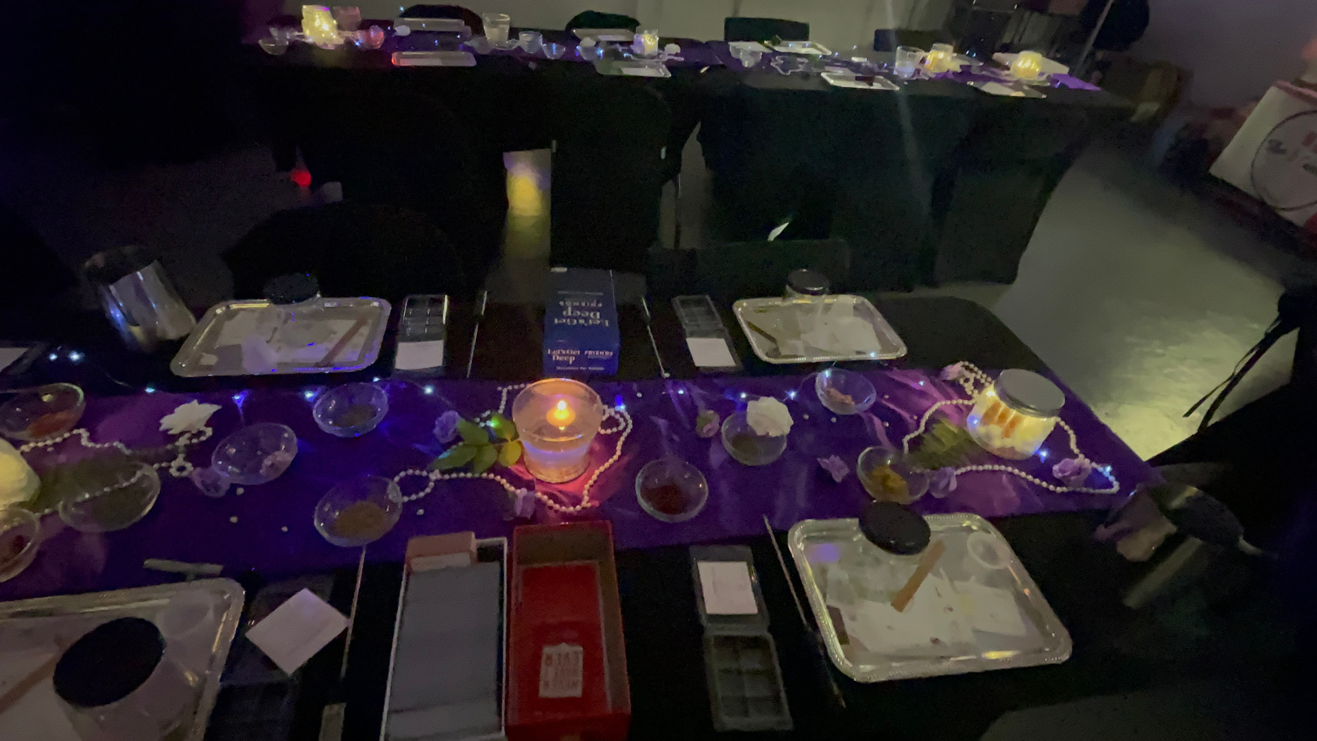 Candlelit purple organza runner with pearls, silver trays and scent stations