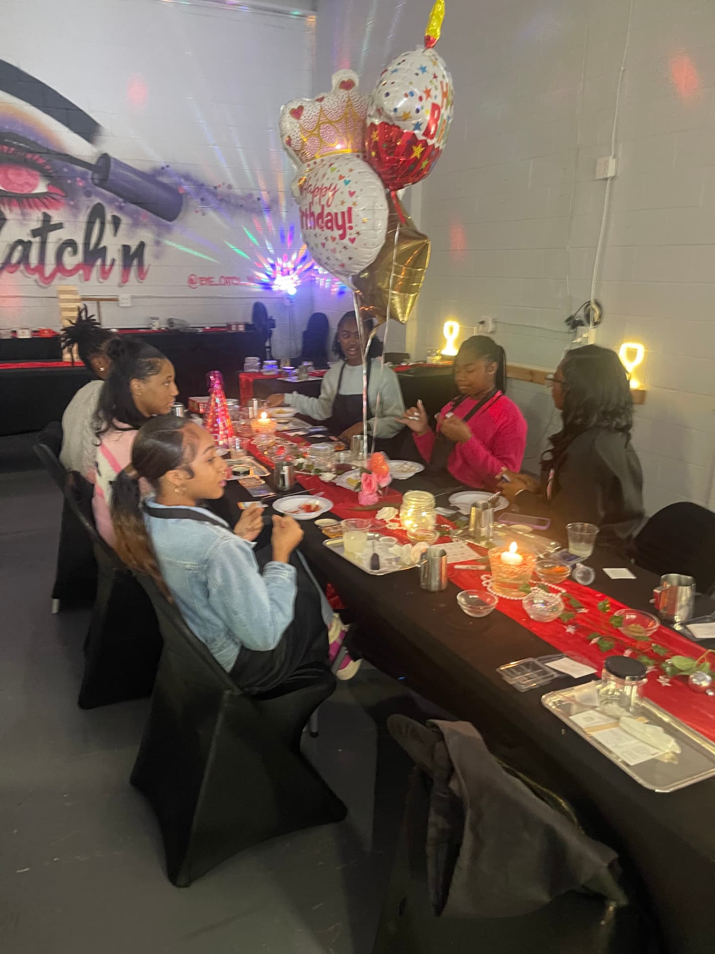 Red runner birthday tablescape with balloons and guest blending stations