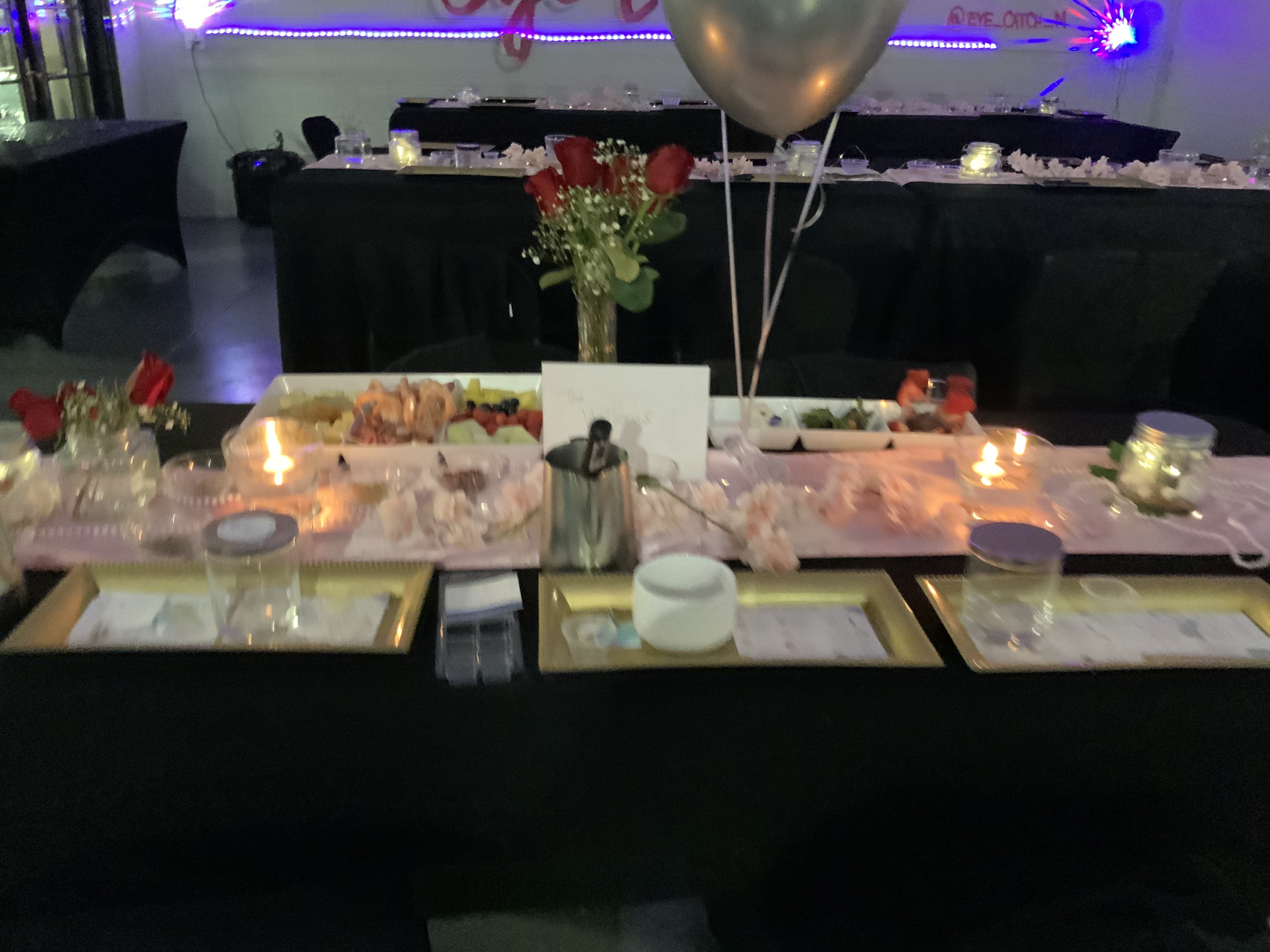 Blush runner tablescape with roses, grazing trays and gold charger stations